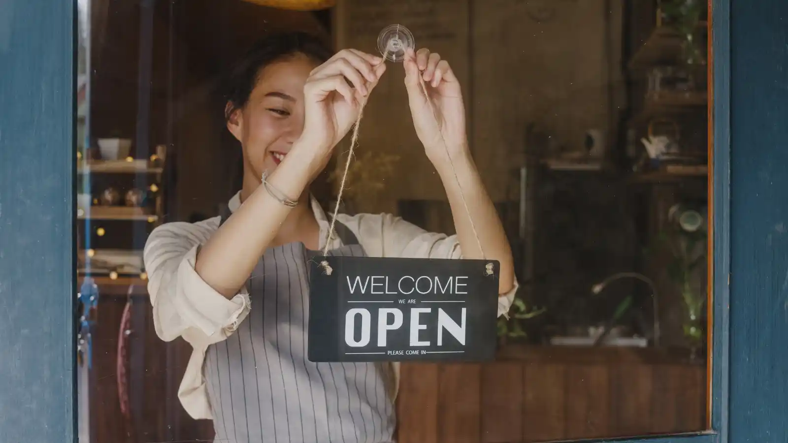 Hero Slide Young Woman Opening Up Storefront